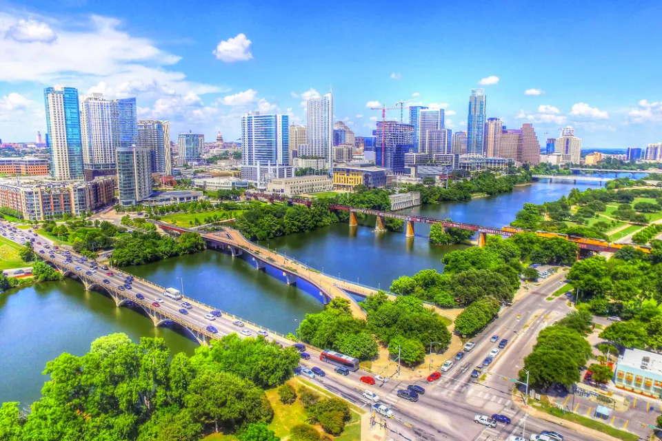 Multiple bridges busy with cars cross Lady Bird Lake outside downtown Austin, Texas.